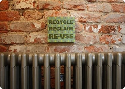 Recycle sign above reclaimed radiator