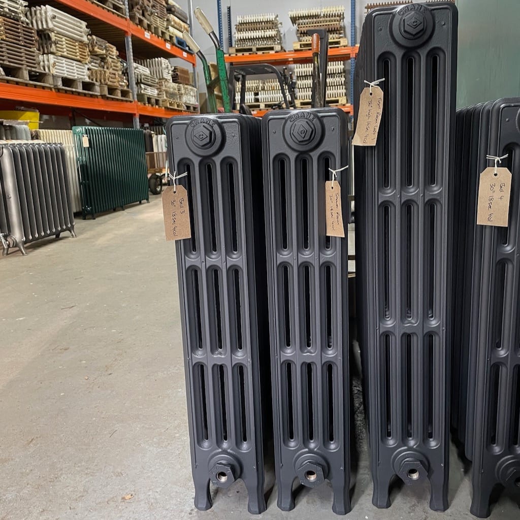 Black old fashioned cast iron radiators with columns