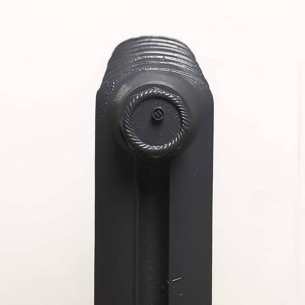 Detail of slim round top cast iron old school radiator